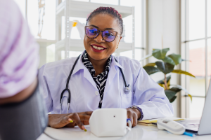 Urgent care provider checking a woman's blood pressure